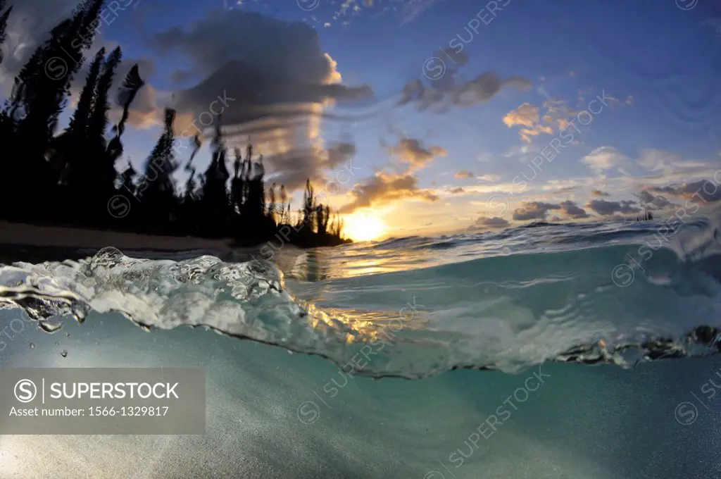Wave breaks at sunrise in the shore of Kanumera Bay, Iles des Pins, New Caledonia, South Pacific.
