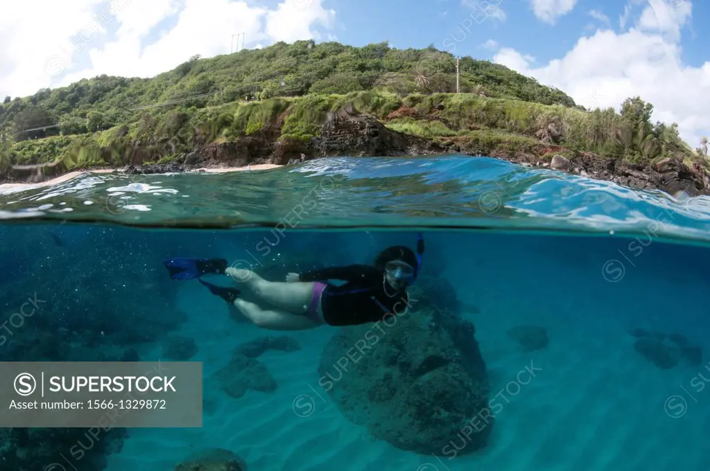 Woman snorkeling in Waimea Bay, North Shore of Oahu, Hawaii, USA.