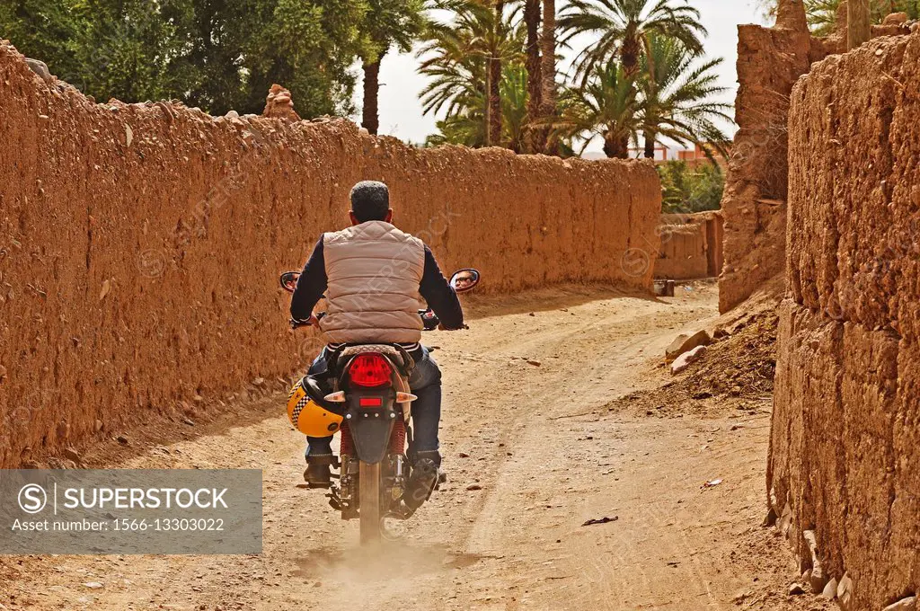 man on a motorcycle, old town, Agdz, Morocco.