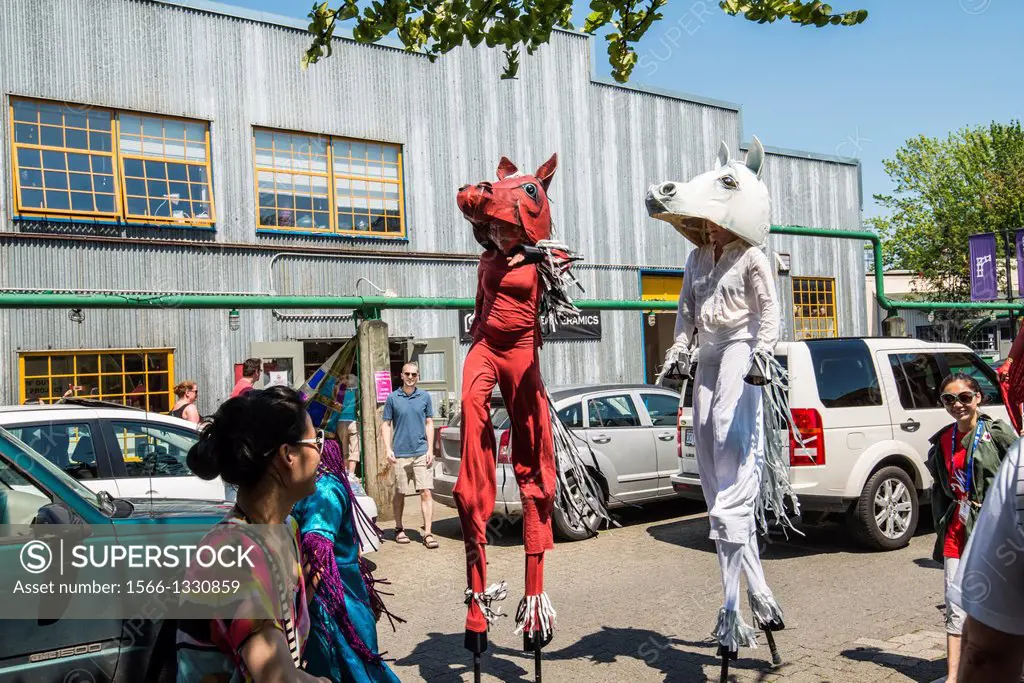 people in costumes form a parade on Canada Day on Granville Island, Vancouver, BC, Canada
