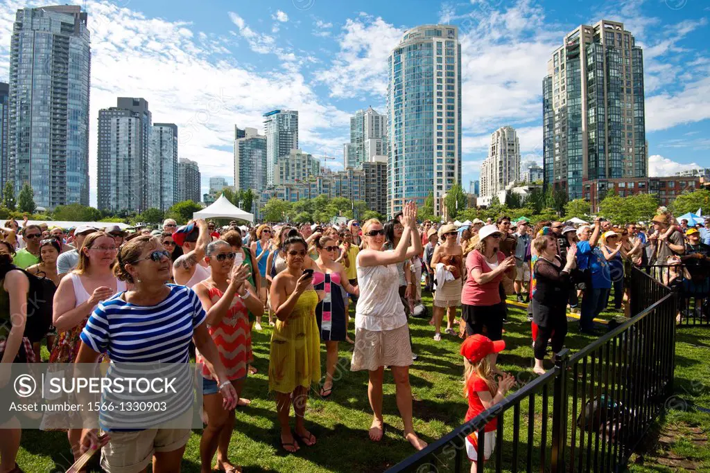 people enjoy the music at the Vancouver International Jazz Festival in David Lam park in Vancouver, BC, Canada.