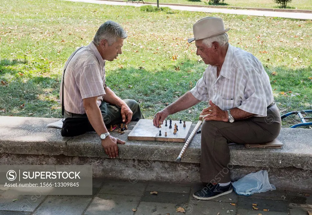 Playing chess, a popular passtime in Albania, on the edge of Rinia Park, Central Tirana, Albania,.