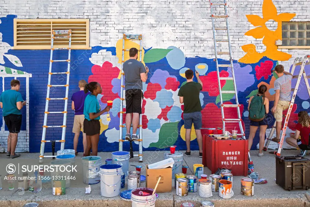 Detroit, Michigan - Youth paint a mural on the wall of a laundromat in the Morningside neighborhood. They are part of the Summer in the City program, ...