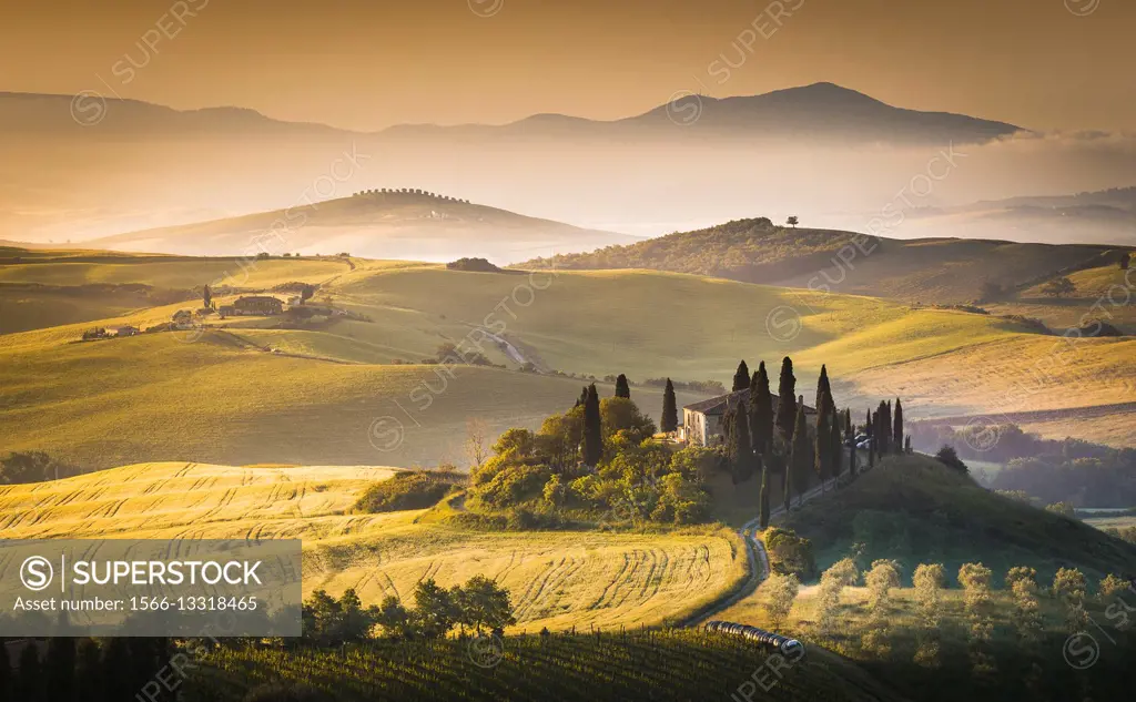 San Quirico d´Orcia, Tuscany, Italy. Podere Belvedere surrounded by hills, during a warm sunrise.