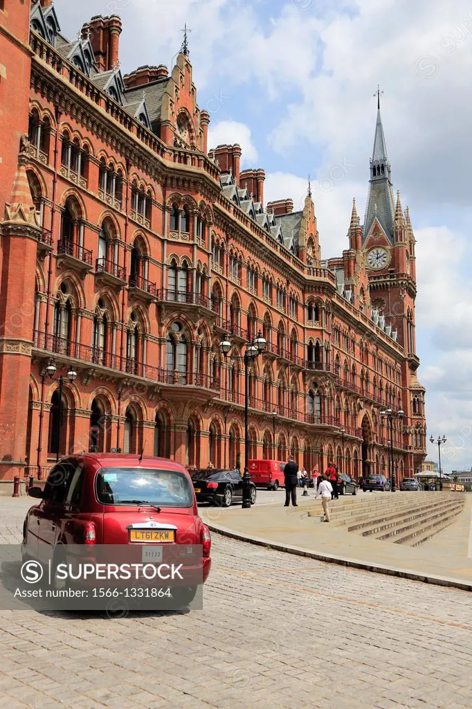 The exterior view of St Pancras railway station with a red taxi in foreground, London, England, UK
