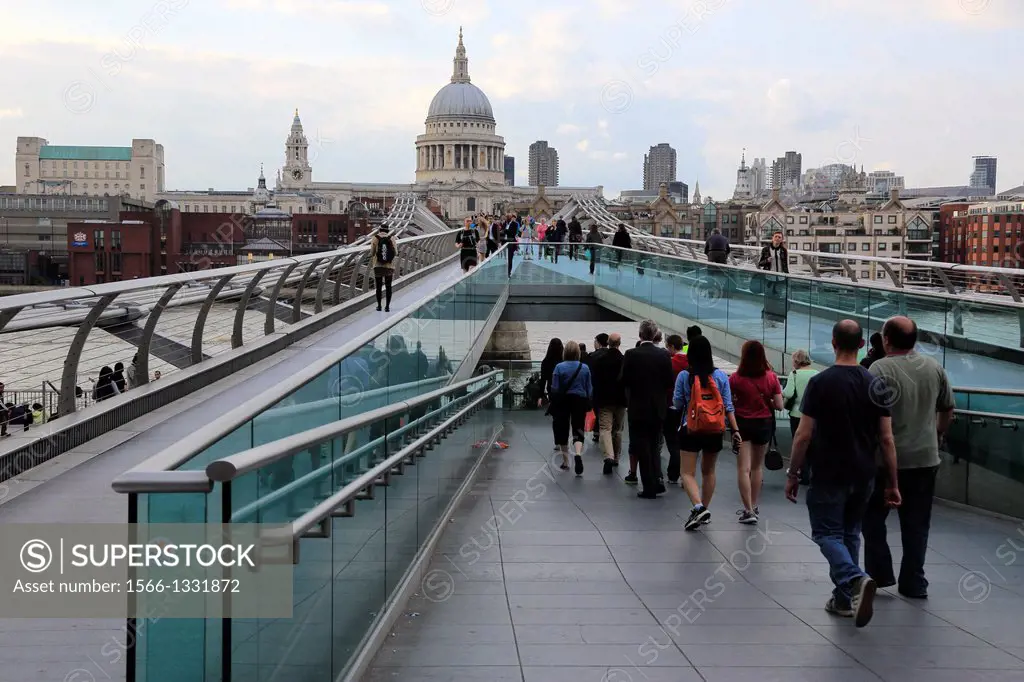 Pedestrians on Millennium Bridge with the dome of St Paul's Cathedral in the background. London. England. United Kingdom.