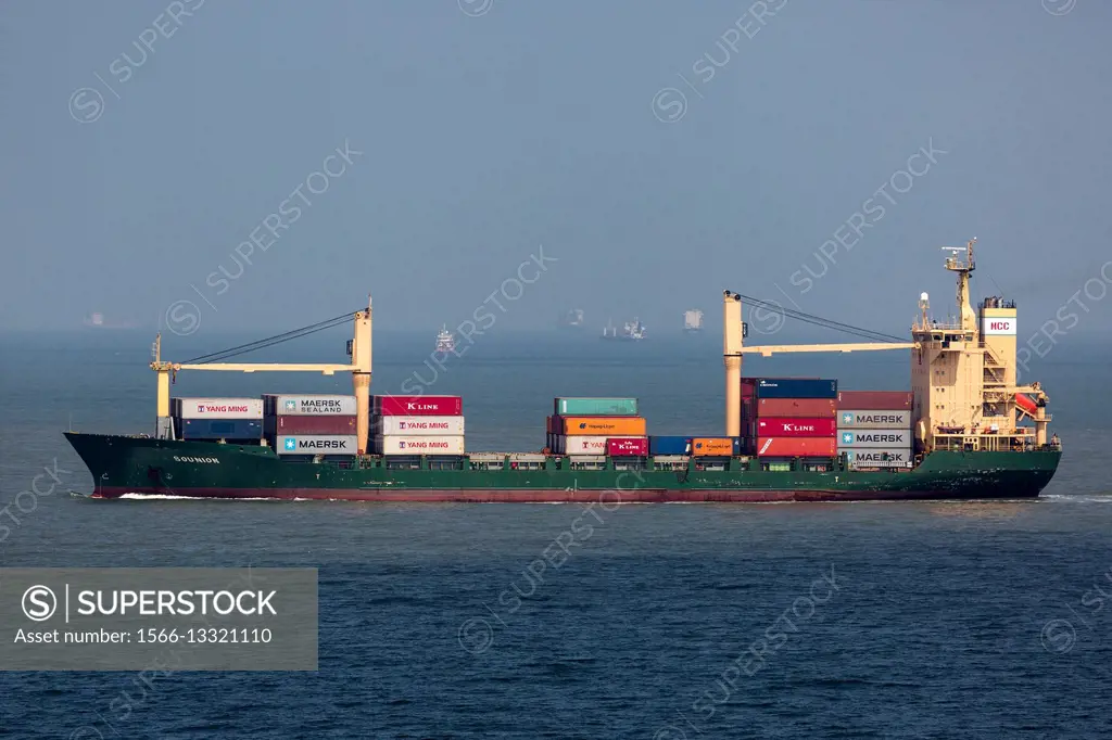 Container ship heading for Port Said passing other ships waiting for passage down Suez Canal Egypt.