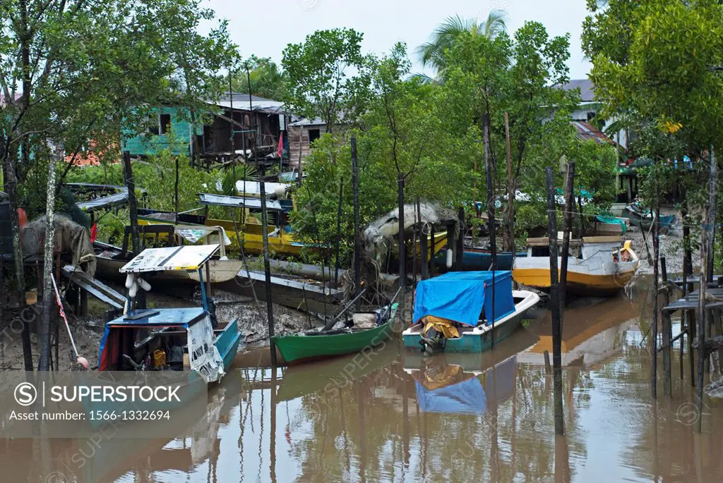 Small fishing boats at berthed along the river bank of Buntal Fishing Village, Sarawak, Malaysia.