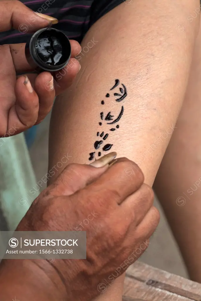 Tattoist at work, Coral Island, Pattaya, Thailand.