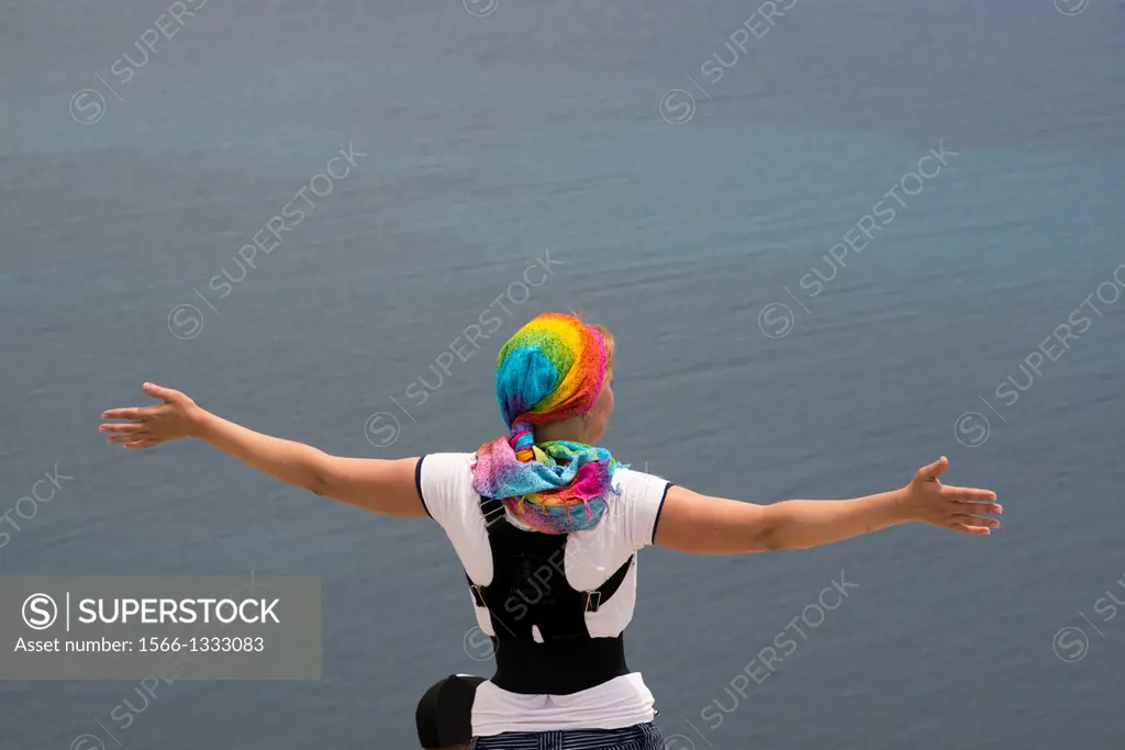 woman at the top of the Rock of Ifach with gesture of freedom, Calpe, Alicante, Spain.