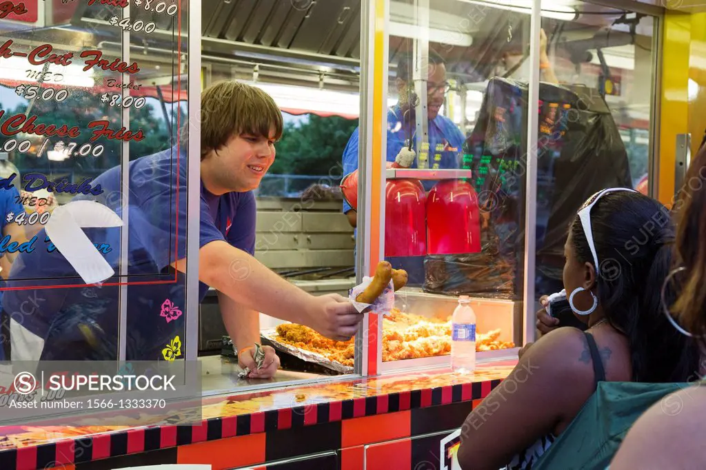 Detroit, Michigan - A young worker serves food at the Detroit River Days Festival, an annual festival of music, food, carnival rides, and other events...