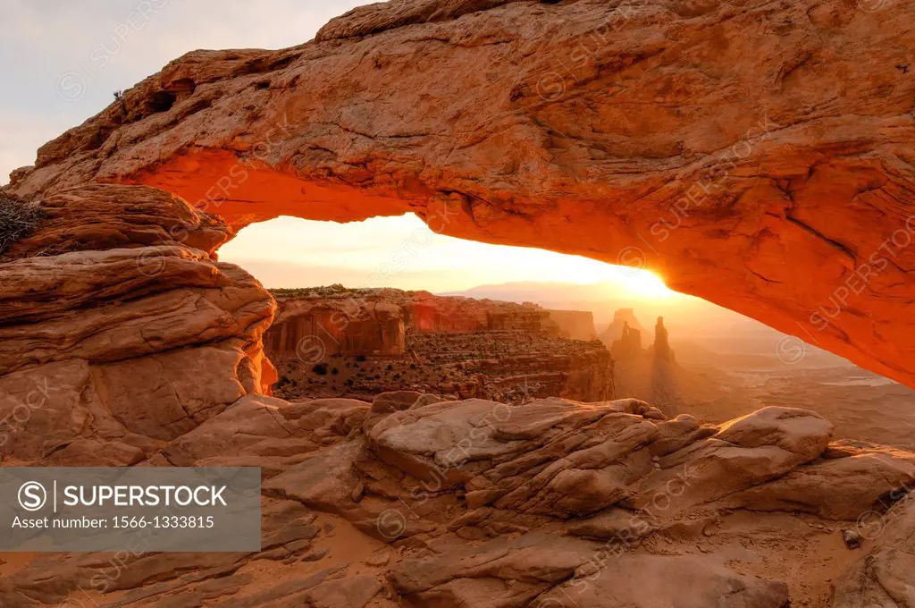 View under Mesa Arch in Canyonlands National Park at sunrise.