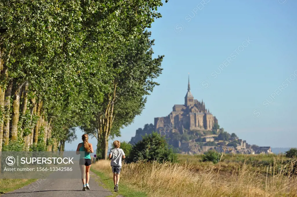 joggers on a path in polders of the Mont-Saint-Michel bay, Manche department, Normandy region, France, Europe.