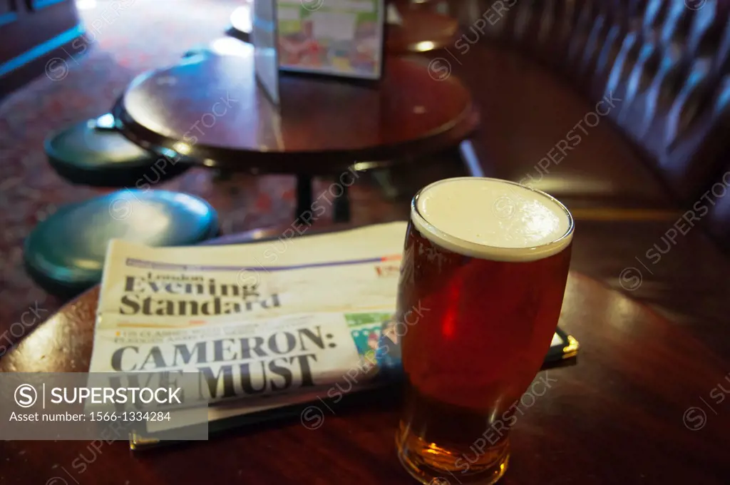 the Evening Standard newspaper and a pint of beer Fitzroy tavern pub London England Britain UK Europe.