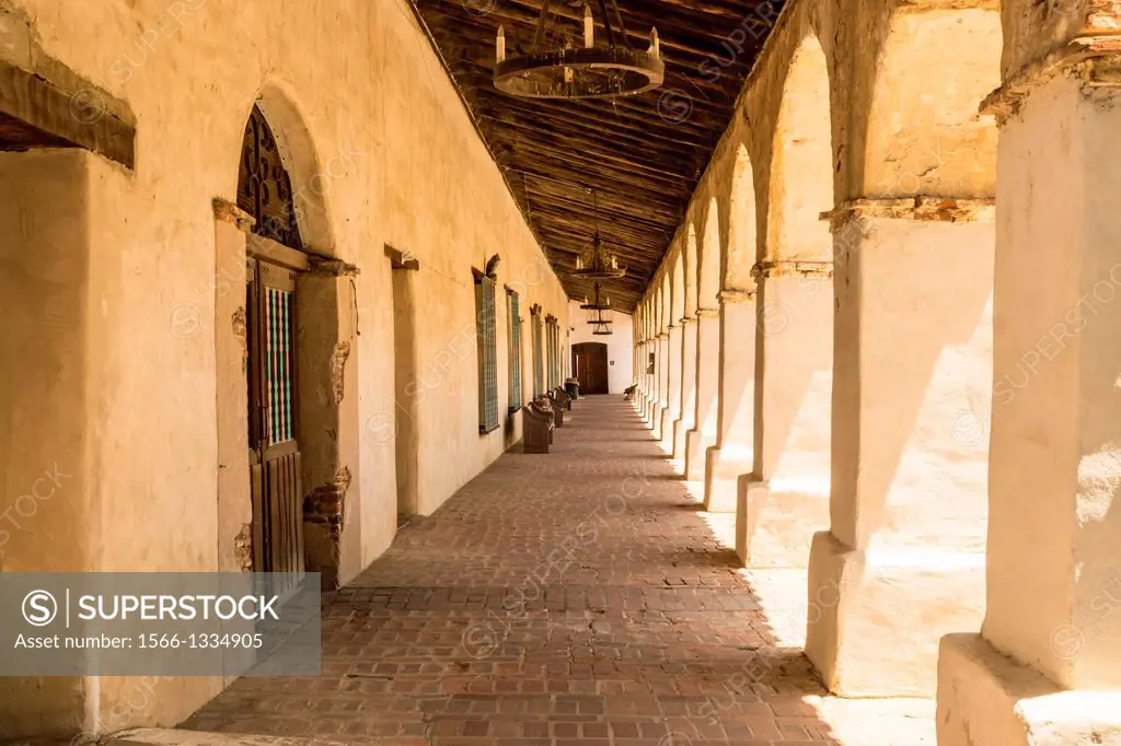 Shaded colonnade at the historic Mission San Miguel Arcangel in California.