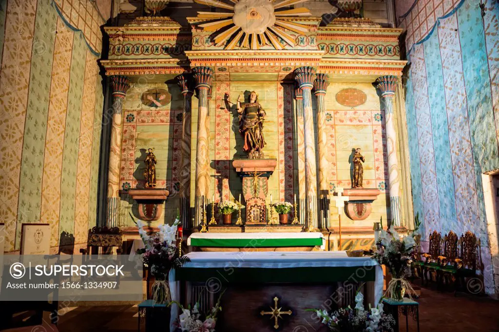 The ornate restored altar of the Spanish colonial mission San Miguel Arcangel in Central California.