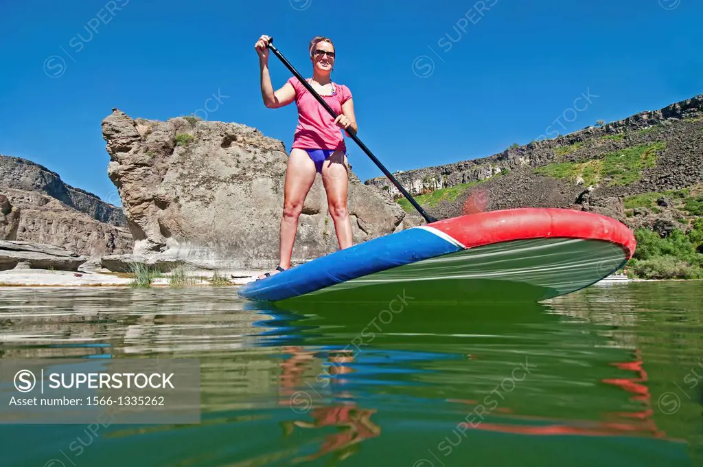 Riding the Stand Up Paddle Board at Pillar Falls on the Snake River in the Snake River Canyon near the city of Twin Falls in southern Idaho.