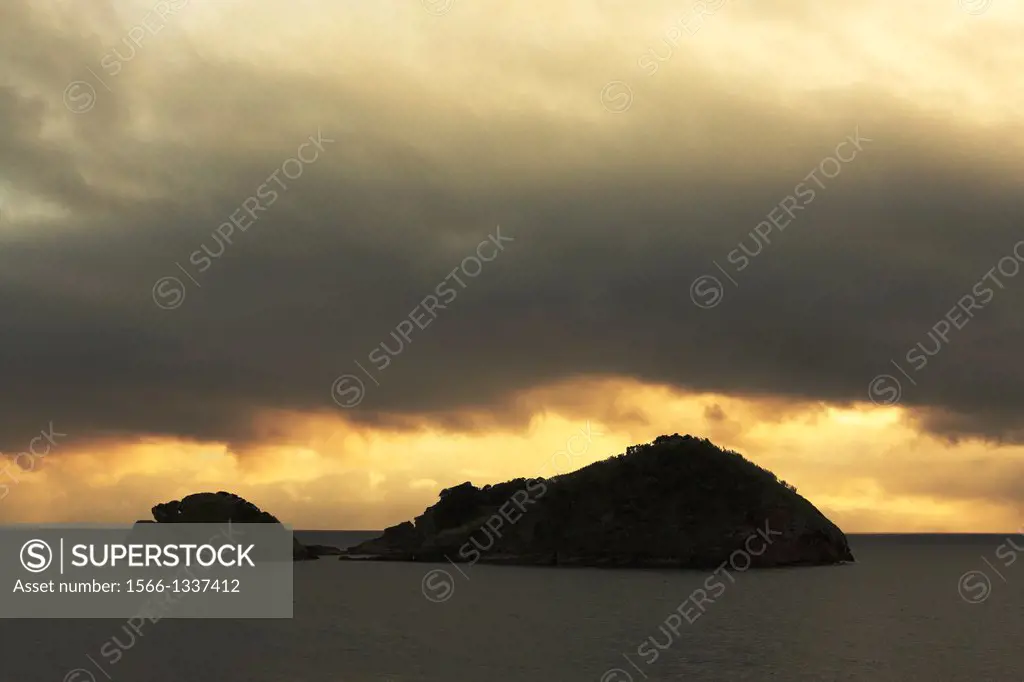 Dark sunset clouds over the islet of Vila Franca do Campo, off the coast of Sao Miguel island. Azores, Portugal.