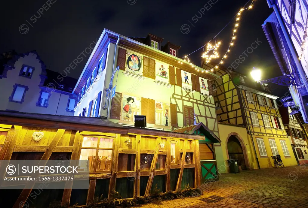Hansi drawings Christmas decoration by night at the Little Venice. Colmar. Wine route. Haut-Rhin. Alsace. France.