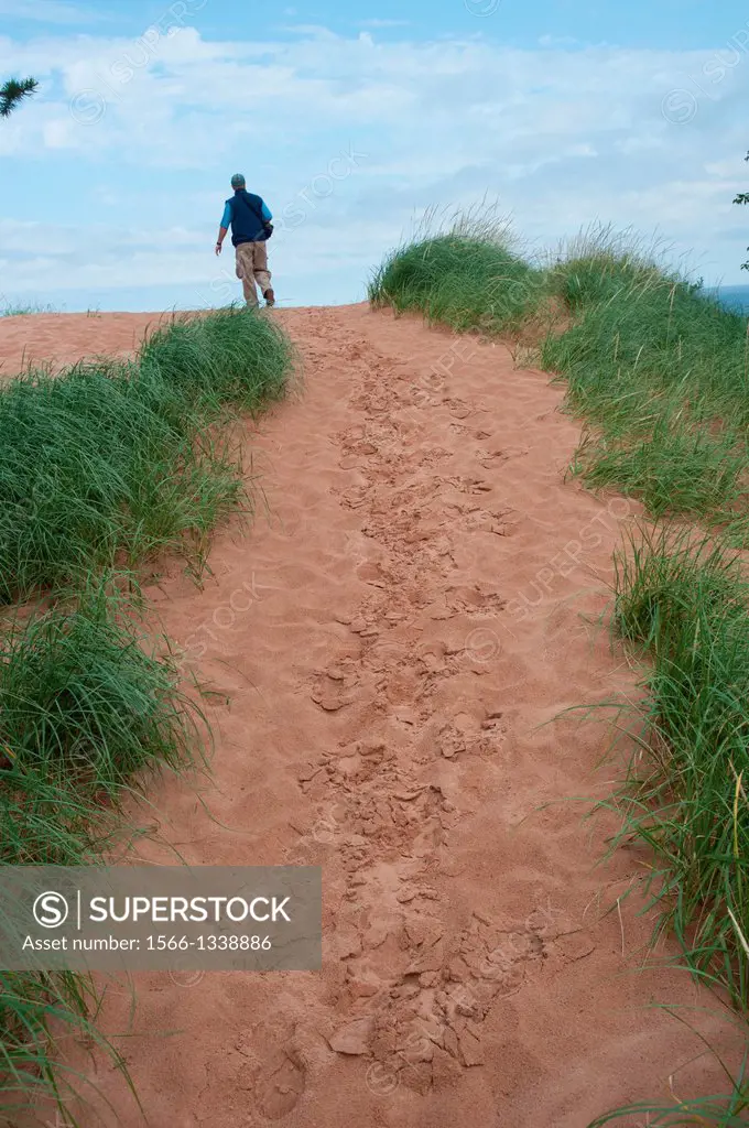 Hiker along Lake Superior sand dunes in Upper Peninsula of Michigan USA.