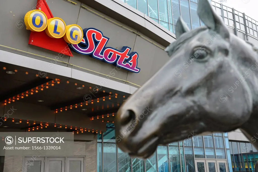 Ontario Lottery and Gaming sign for slots with sculpture of Northern Dancer at Woodbine Racetrack in Toronto.