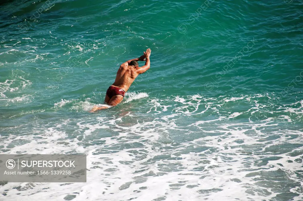 single man jumping to the sea for swimming, Amalfi, Amalfi Coast, Italy, March.