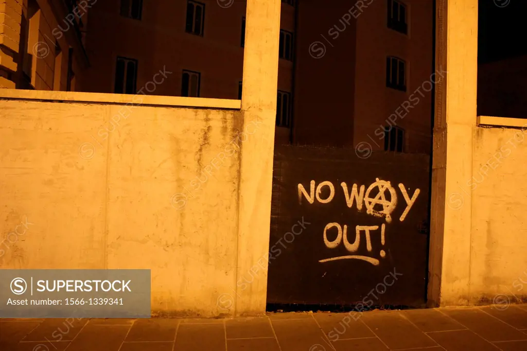 no way out graffiti on gate on road street in rome italy.