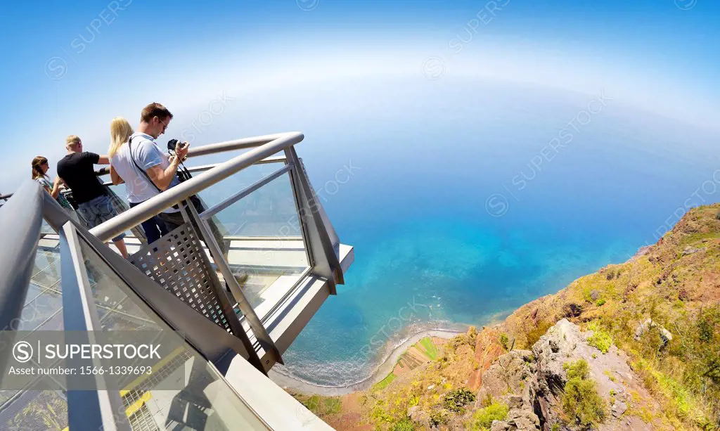 Tourist on the panoramic terrace at the top of Cabo Girao (580 m highest) cliff - Camara de Lobos, Madeira, Portugal.
