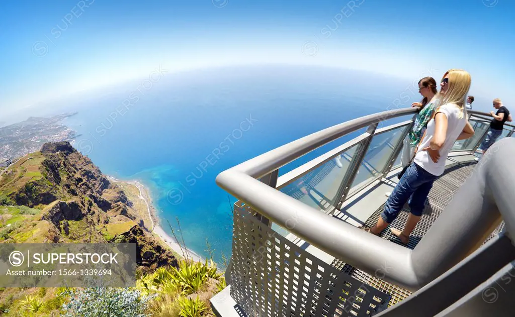 Tourist on the panoramic terrace at the top of Cabo Girao (580 m highest) cliff - Camara de Lobos, Madeira, Portugal.