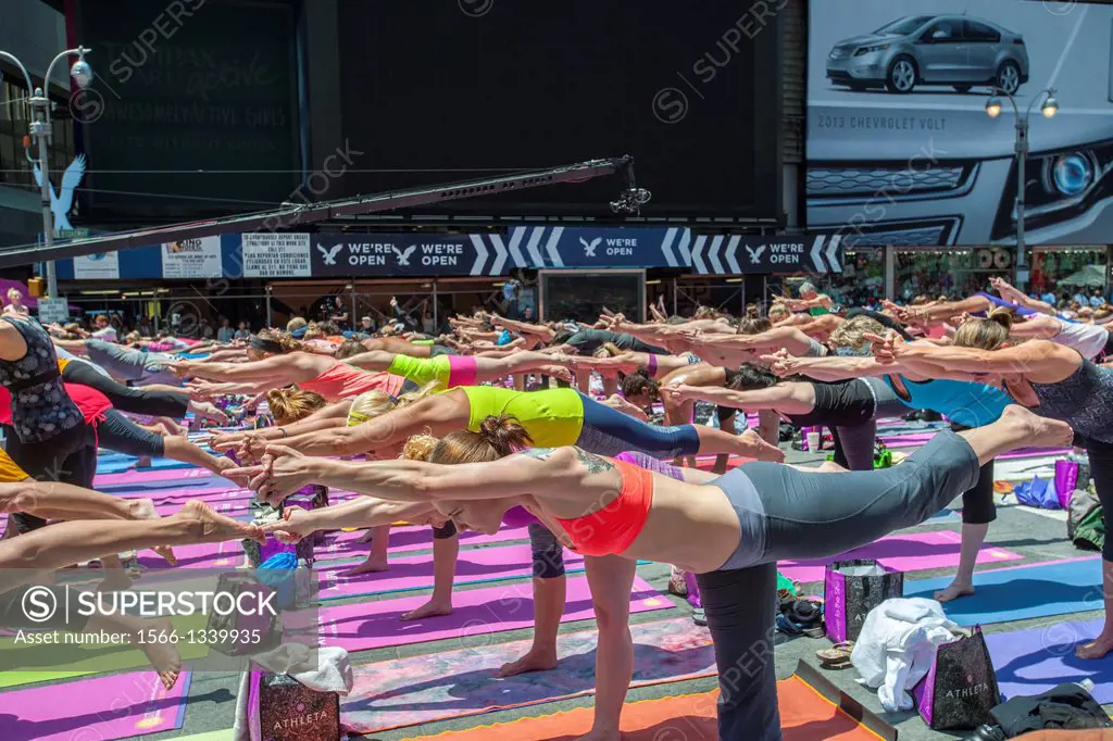 Thousands of yoga practitioners pack Times Square in New York to participate in a mid-day Bikram Yoga class on the first day of summer. The 11th annua...