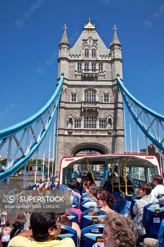 London Tour Bus Travelling Over Tower Bridge, London, England.