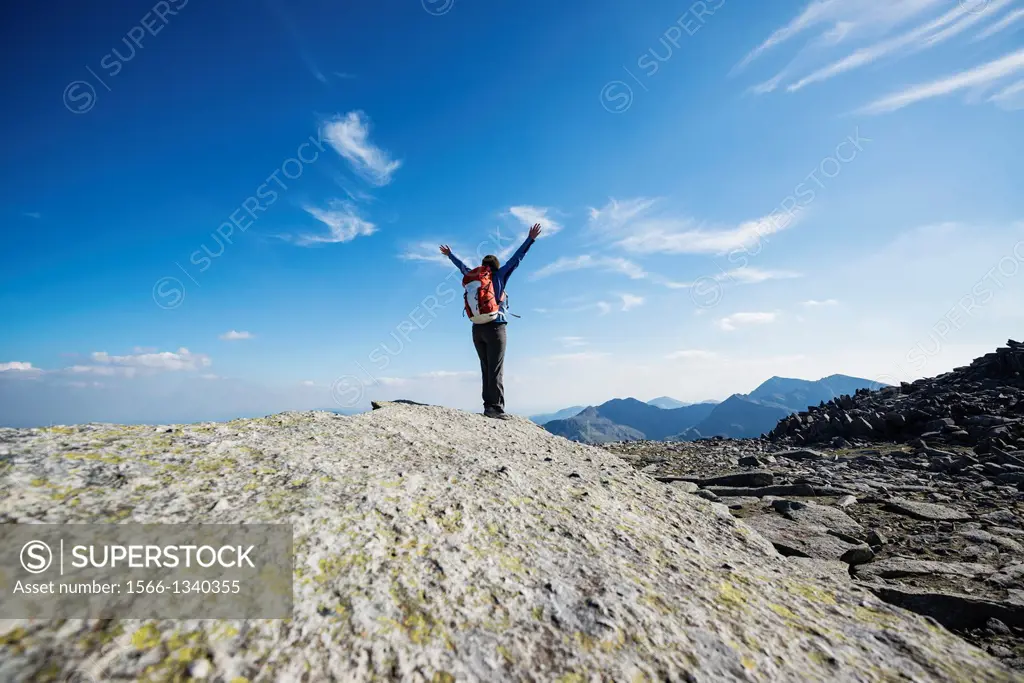 Female hiker on Cantilever stone, Glyder Fach, Snowdonia national park, Wales.