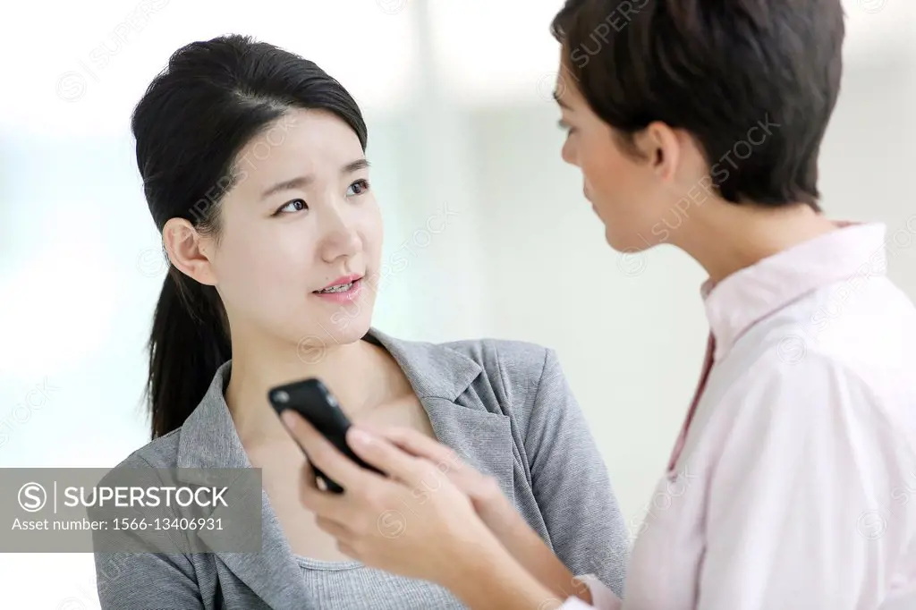 Two Businesswomen using smartphone