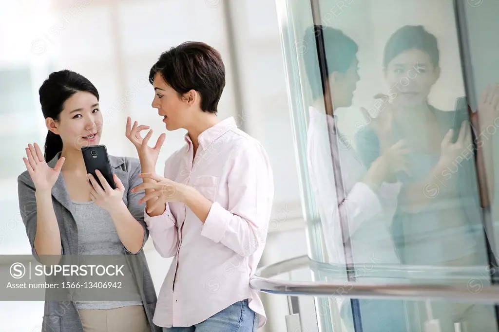 Two Businesswomen using smartphone