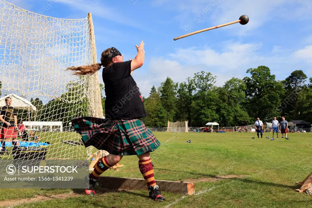 Competitor at Scottish highland games throwing the 22 pound hammer, a traditional Scottish competition taking place at Balloch near Loch Lomond, Glasg...