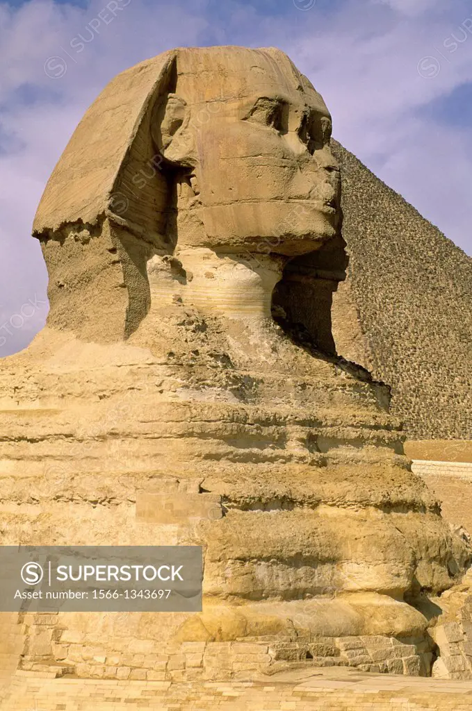 EGYPT, CAIRO, GIZA, SPHINX WITH CHEOPS PYRAMID IN BACKGROUND.