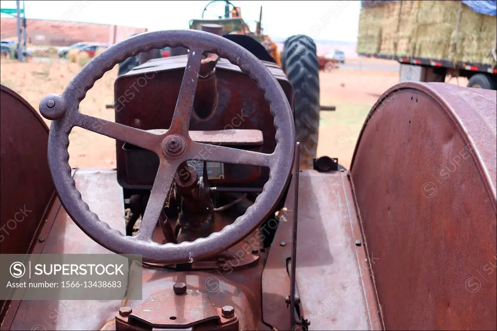 An old tractor dreams of past glory in Page (Arizona, USA) as it rusts away under a hot desert sun
