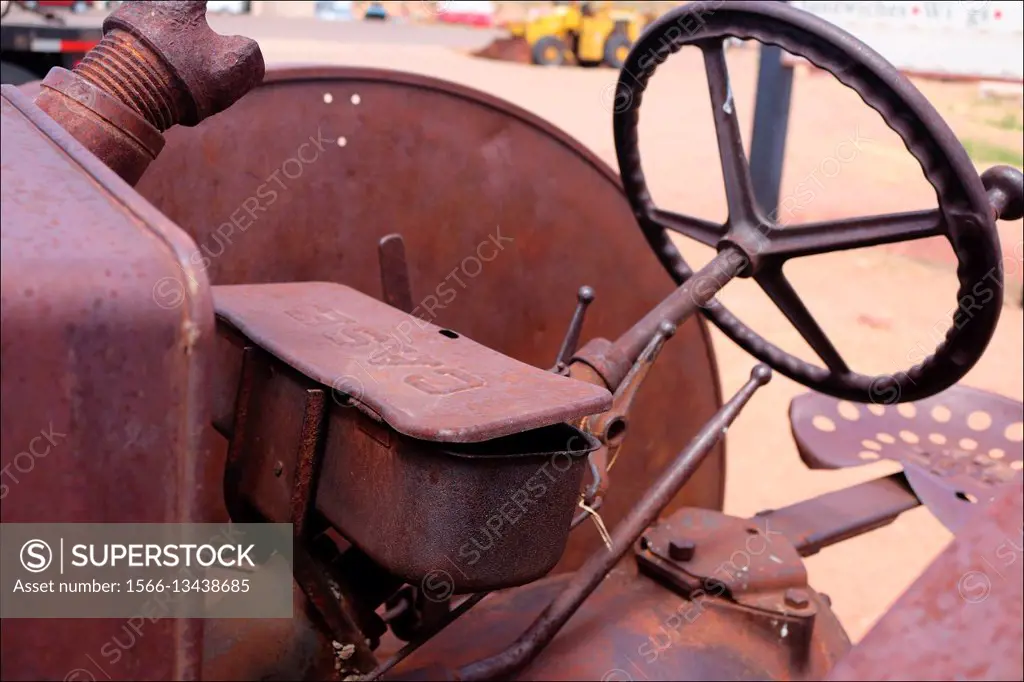 An old tractor rusts away under a hot desert sun in Page, Arizona, USA