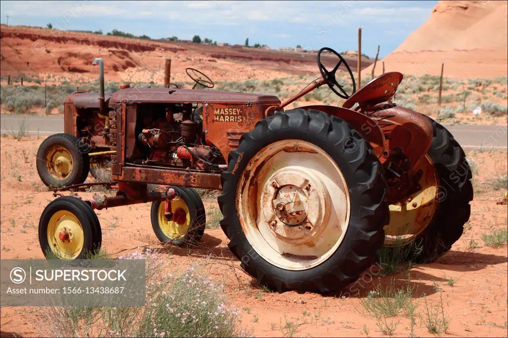 Old tractors rust away under a hot desert sun in Page, Arizona, USA