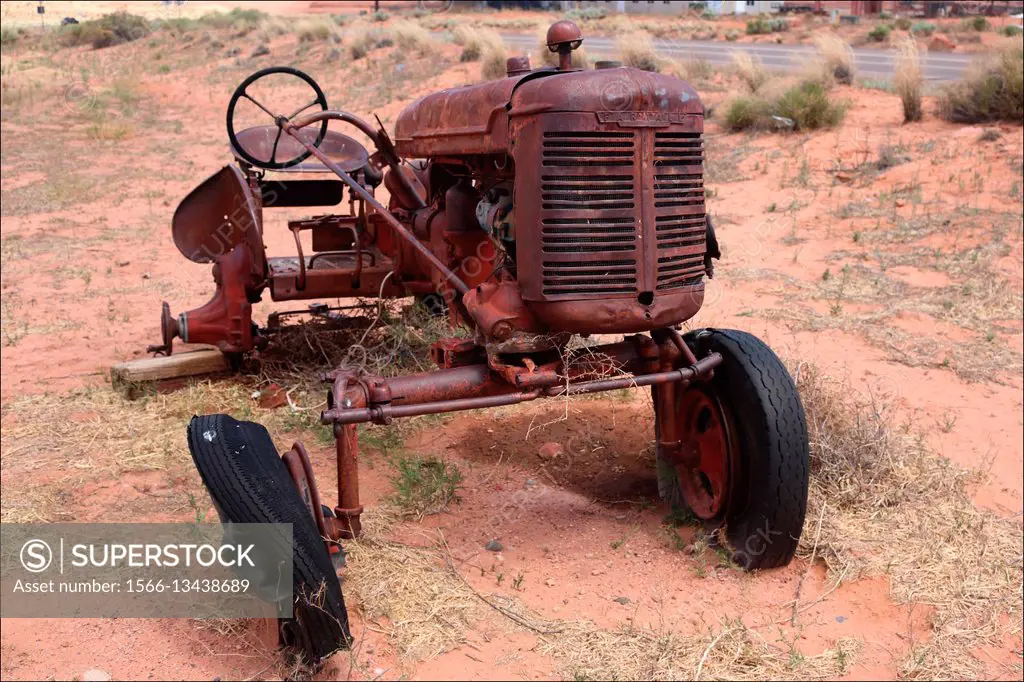 An old tractor dreams of past glory in Page (Arizona, USA) as it rusts away under a hot desert sun