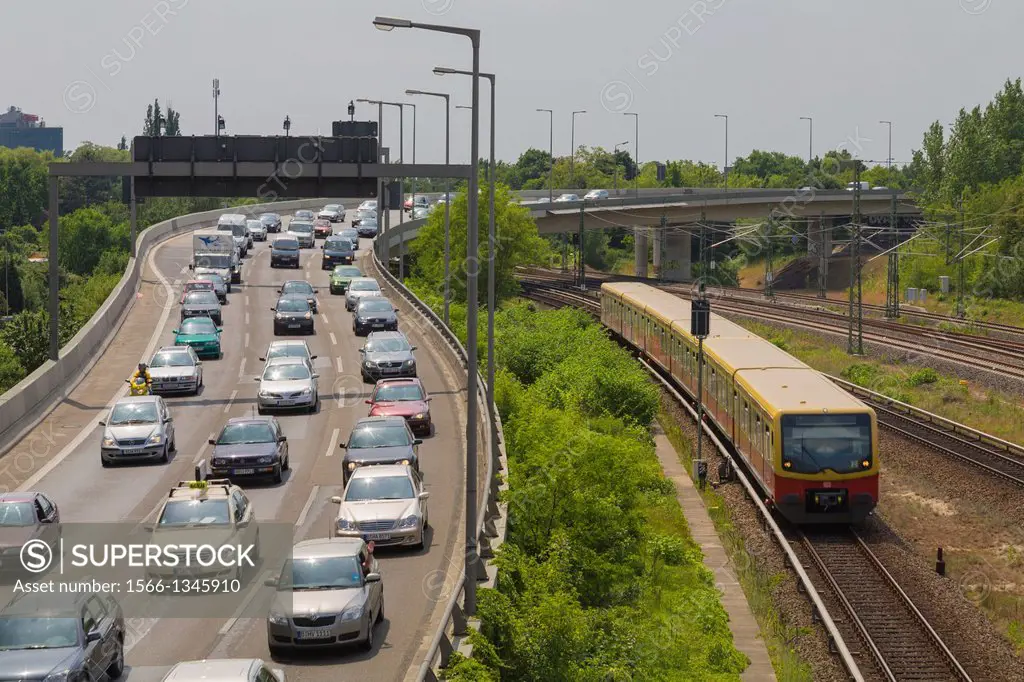 Traffic jam at city motorway ""Stadtautobahn"" on a car free Sunday, a commuter local train ""S-Bahn"" bypass the traffic jam, Charlottenburg-Wilmersd...