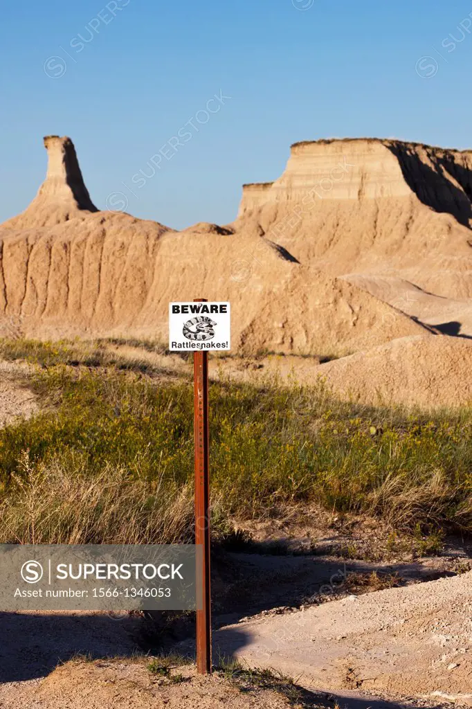 Rattlesnake warning sign along a hiking trail, Badlands National Park, South Dakota, United States of America.