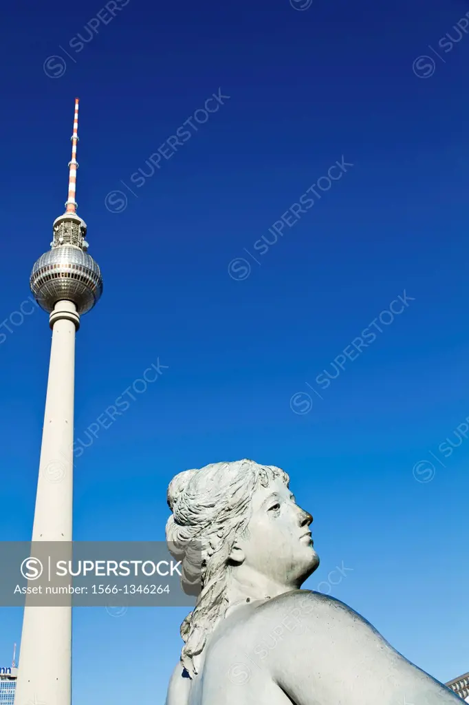 Statue of the Neptun Fountain and TV Tower on Alexanderplatz in Berlin, Germany.