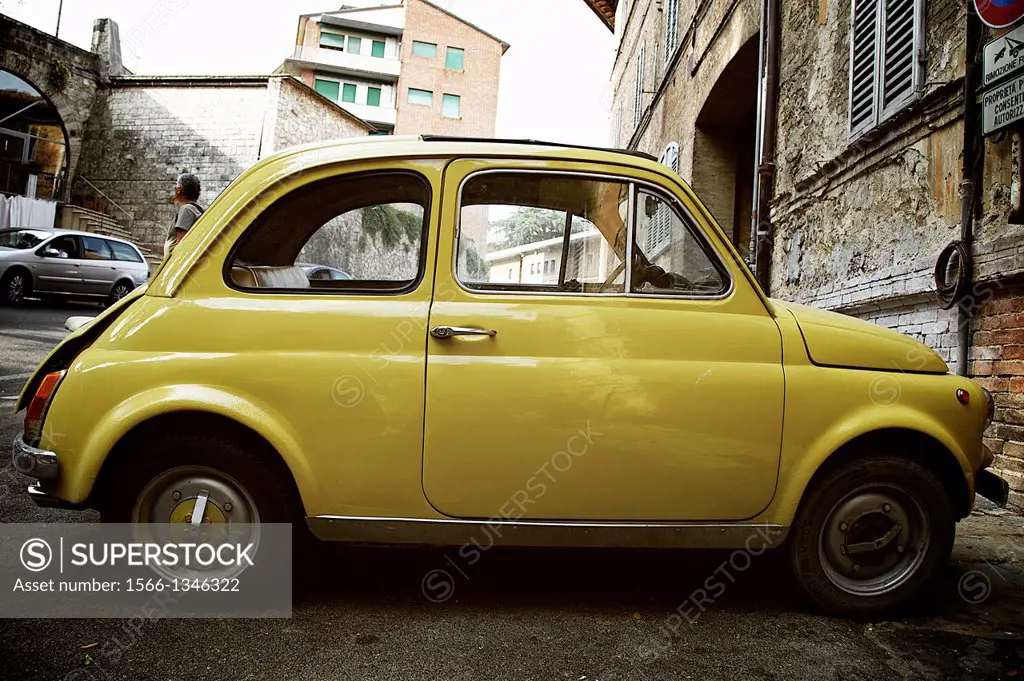 Old yellow fiat park in Siena-Italy