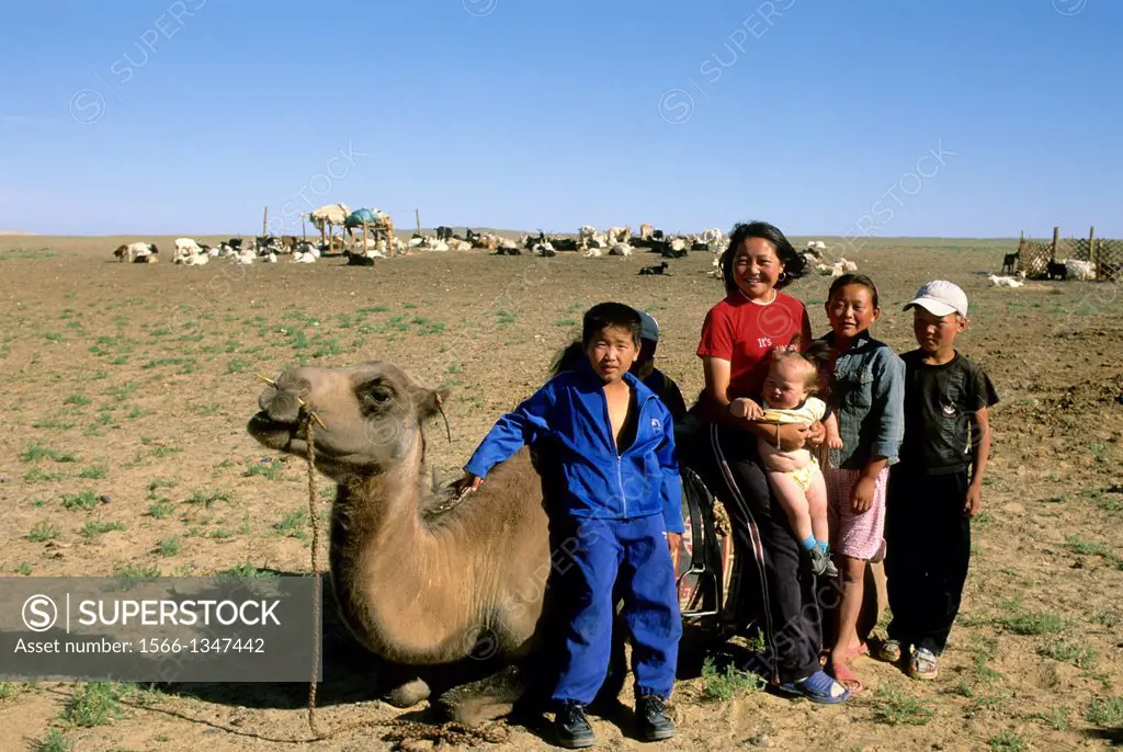 MONGOLIA, NEAR DALANZADGAD, GOBI DESERT AT KHONGORYN ELS (SAND DUNES),FAMILY WITH BACTRIAN CAMEL.