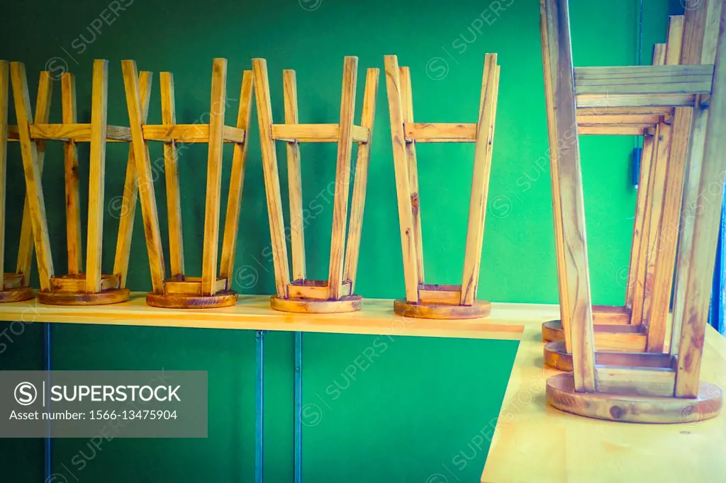 Wooden stools over a bar, closed bar.