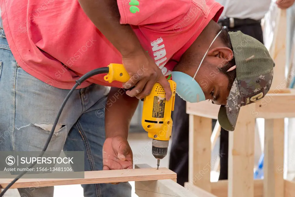 Agua Prieta, Sonora, Mexico - Workers who have been deported from the United States build furniture, using wood from shipping pallets. They are at Cen...
