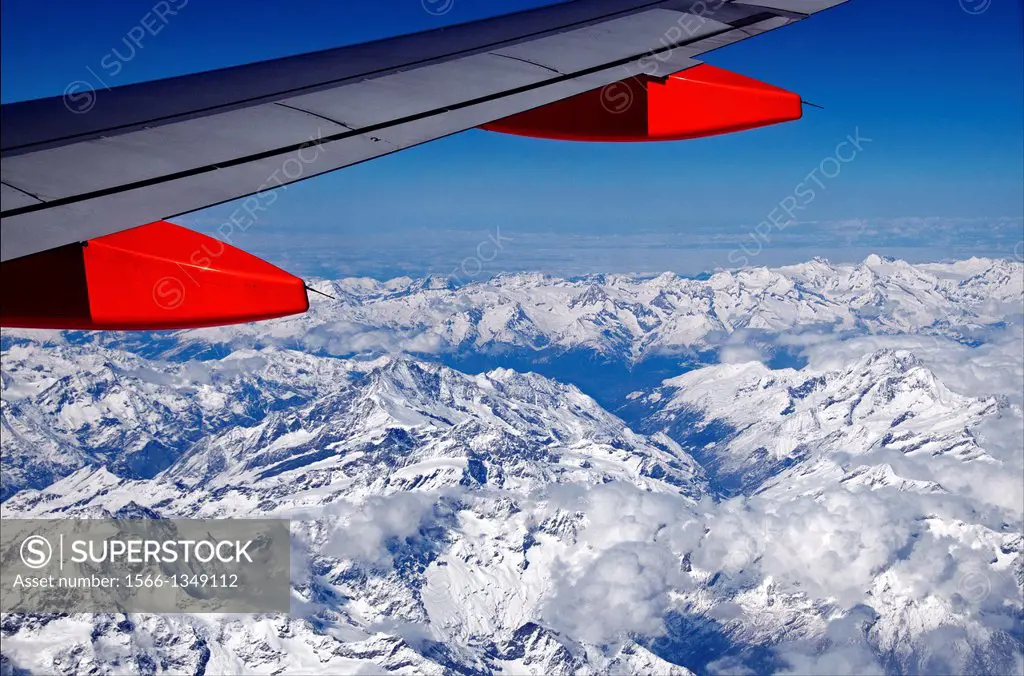 jet plane flying over Swiss Alps.