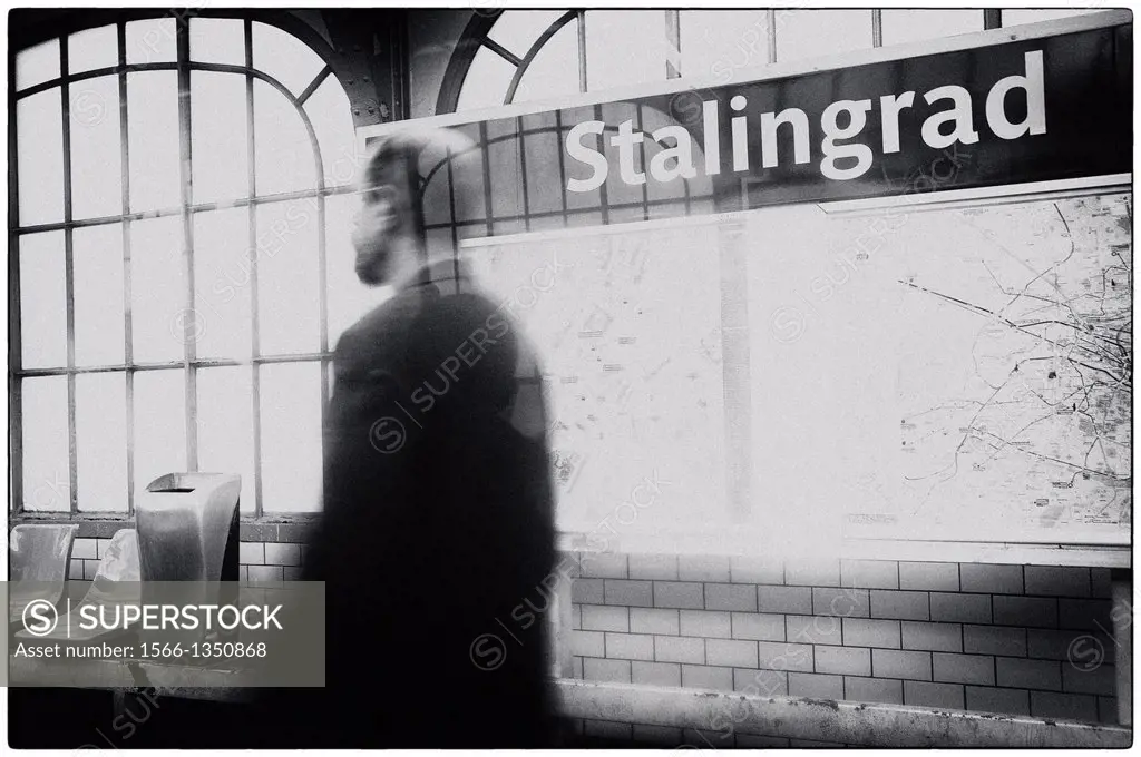 Unrecognizable man in motion, walking in the Stalingrad metro station of Paris, France