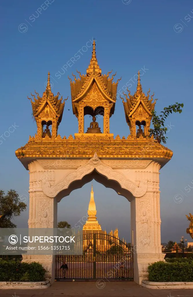 LAOS, VIENTIANE, THAT LUANG STUPA, GATE, EVENING LIGHT.